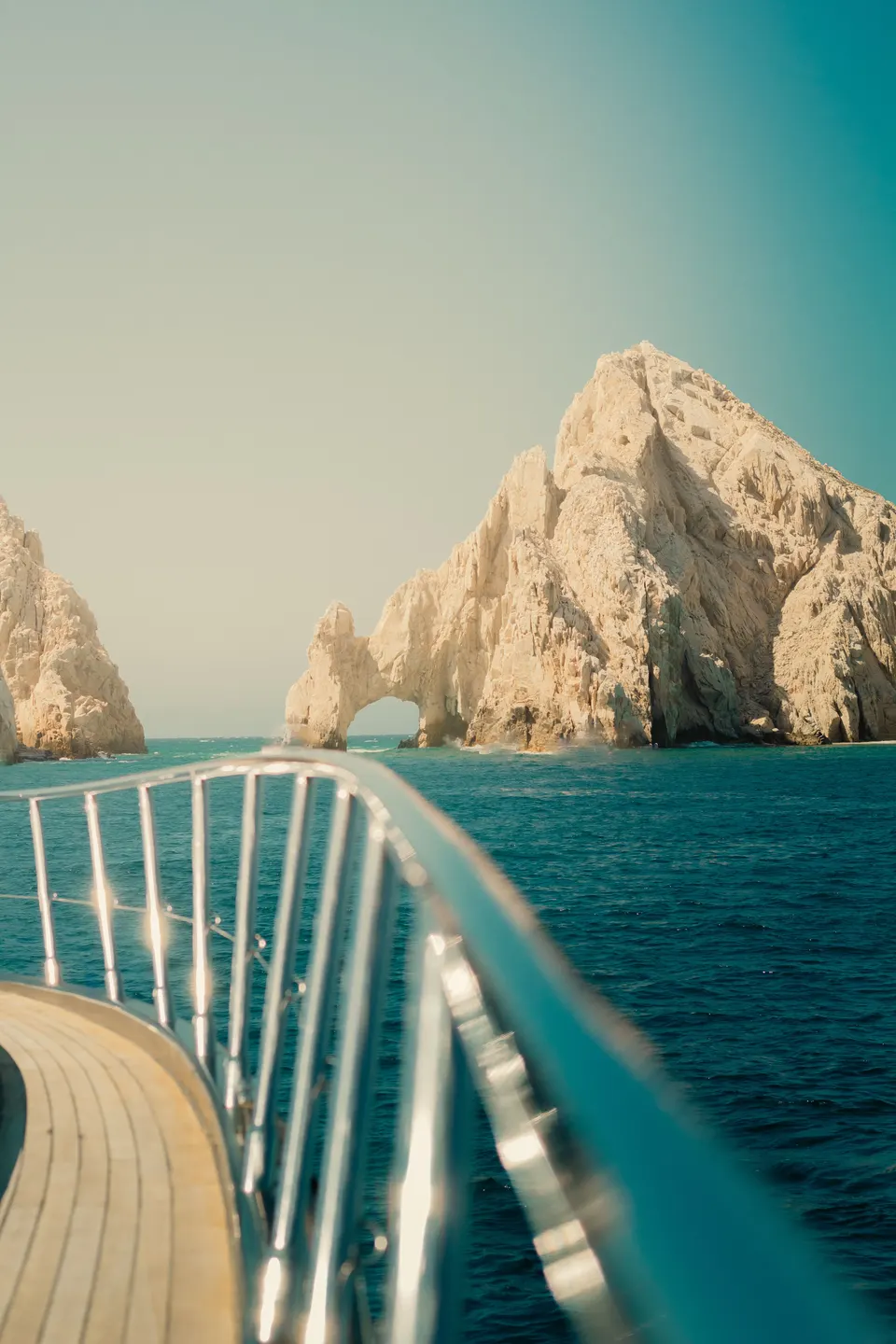 The Arch of Cabo San Lucas at Land's End, seen from the bow of a yacht.